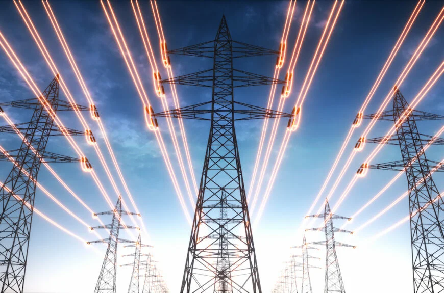 Electricity transmission towers with red glowing wires